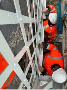 Electricians working from the under deck gantry