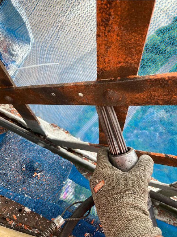 A needle gun removes old paint